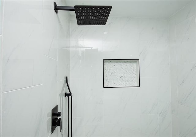 interior details with a tile shower