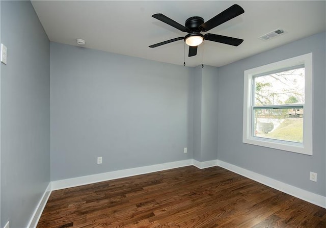 unfurnished room featuring dark wood-type flooring and ceiling fan