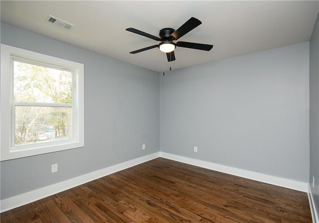 unfurnished room featuring dark wood-type flooring and ceiling fan