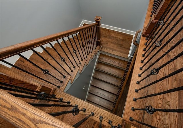 stairway featuring wood-type flooring