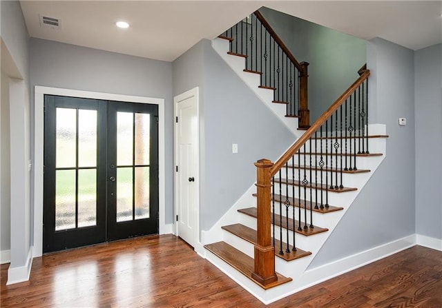 entrance foyer featuring french doors, a healthy amount of sunlight, and wood-type flooring