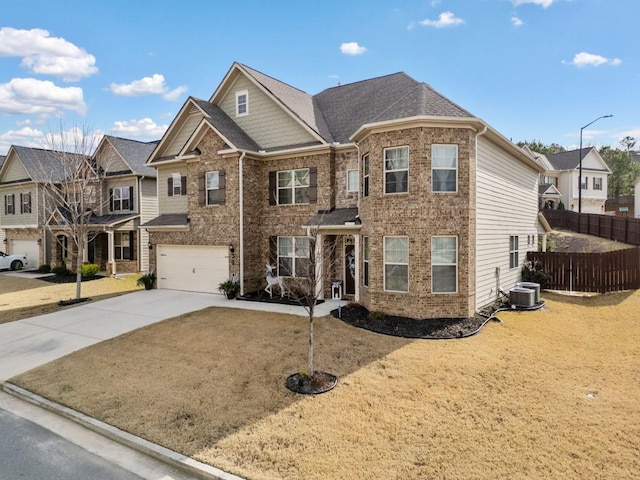 view of front of home featuring central air condition unit, a front lawn, and a garage