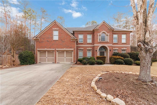 view of front of house with driveway, brick siding, and an attached garage