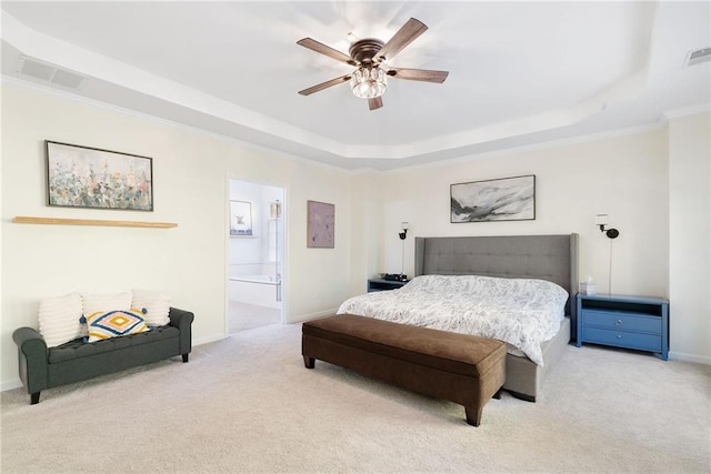 bedroom with a tray ceiling, carpet flooring, visible vents, and baseboards