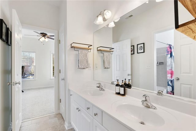 bathroom featuring ceiling fan, curtained shower, a sink, and double vanity