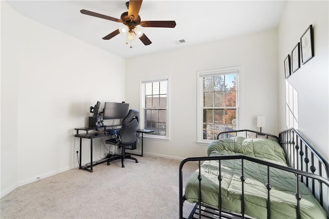 carpeted bedroom featuring baseboards, visible vents, and ceiling fan