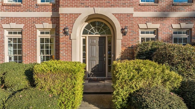 doorway to property with brick siding