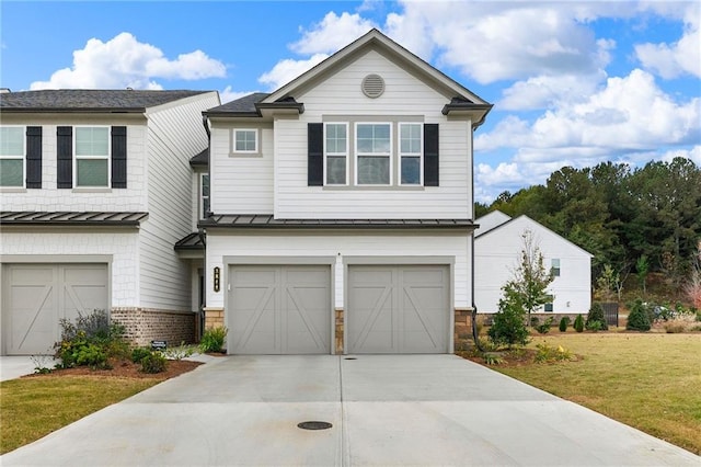 view of front of property with a garage and a front lawn