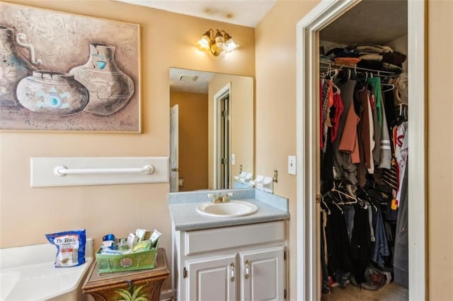 60 Boardwalk Ave, Covington, GA 30016 - bathroom featuring vanity and a spacious closet