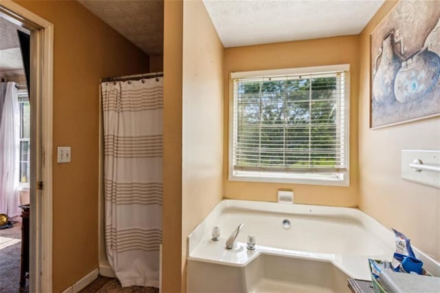 60 Boardwalk Ave, Covington, GA 30016 - bathroom featuring a bath, a textured ceiling, and curtained shower