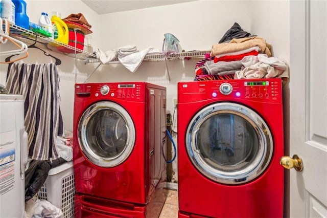 60 Boardwalk Ave, Covington, GA 30016 - laundry area with washing machine and clothes dryer, tile patterned flooring, and water heater