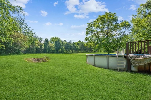 60 Boardwalk Ave, Covington, GA 30016 - view of grassy yard with an outdoor pool and a wooden deck