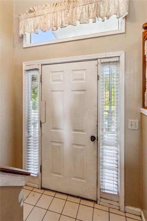 60 Boardwalk Ave, Covington, GA 30016 - entryway with light tile patterned floors and healthy amount of natural light