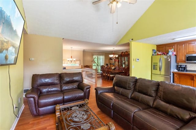 60 Boardwalk Ave, Covington, GA 30016 - living room featuring a chandelier, light wood-style flooring, vaulted ceiling, and ceiling fan