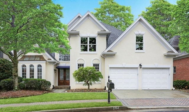 3714 Westbrooke Cir NE, Brookhaven, GA 30319 - view of front facade featuring stucco siding, driveway, and french doors