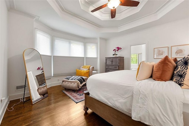 3714 Westbrooke Cir NE, Brookhaven, GA 30319 - bedroom with ornamental molding, multiple windows, wood finished floors, a tray ceiling, and ceiling fan