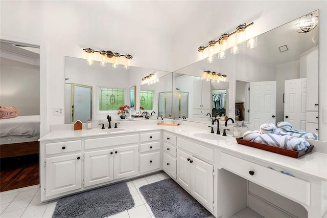 3714 Westbrooke Cir NE, Brookhaven, GA 30319 - ensuite bathroom featuring tile patterned flooring, double vanity, a shower with door, and a towering ceiling