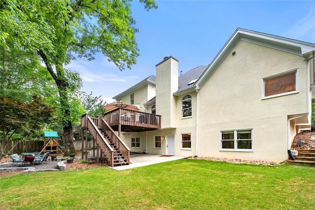 3714 Westbrooke Cir NE, Brookhaven, GA 30319 - back of property with a patio area, a wooden deck, stucco siding, stairs, and a chimney