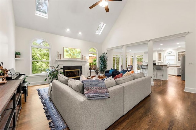 3714 Westbrooke Cir NE, Brookhaven, GA 30319 - living room featuring high vaulted ceiling, a premium fireplace, a ceiling fan, dark wood-type flooring, and recessed lighting