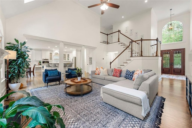 3714 Westbrooke Cir NE, Brookhaven, GA 30319 - living room with a high ceiling, wood finished floors, a ceiling fan, stairs, and recessed lighting