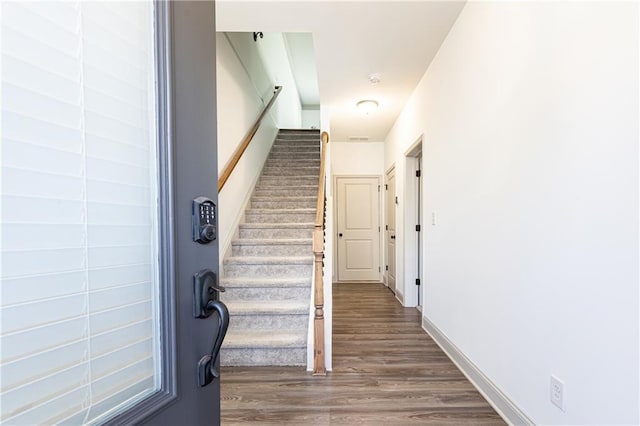 stairway with hardwood / wood-style flooring