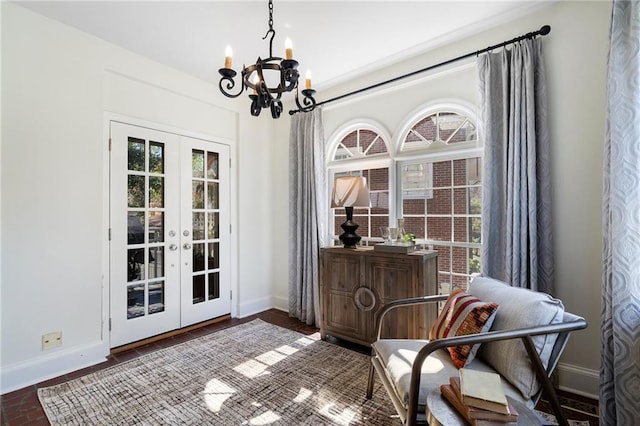 dining area featuring a notable chandelier, french doors, and baseboards