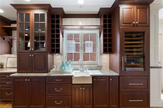 bar featuring wine cooler, french doors, a sink, and decorative backsplash