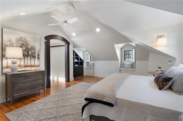 bedroom with arched walkways, ceiling fan, wood finished floors, vaulted ceiling, and recessed lighting