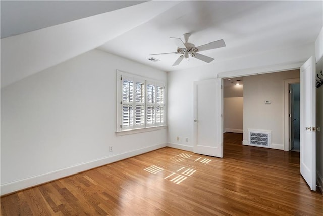 unfurnished bedroom with visible vents, ceiling fan, baseboards, and wood finished floors