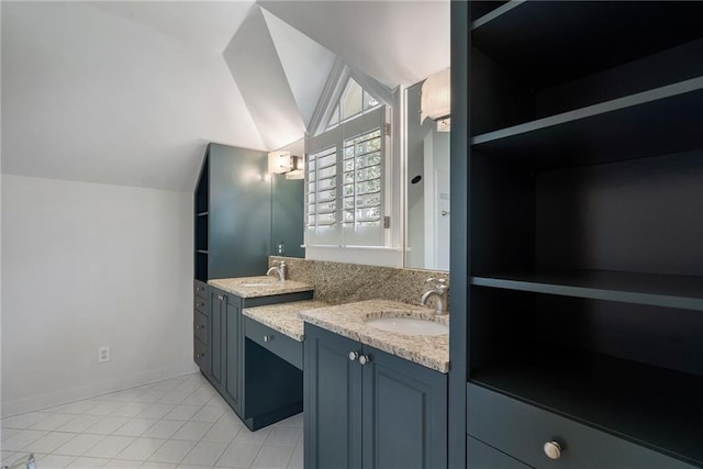 bathroom featuring lofted ceiling, tile patterned flooring, vanity, and baseboards