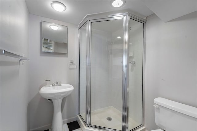 full bathroom with a shower stall and toilet