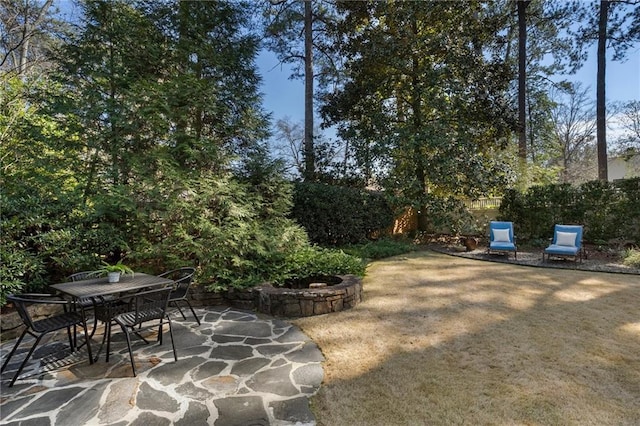 view of patio featuring outdoor dining area and fence