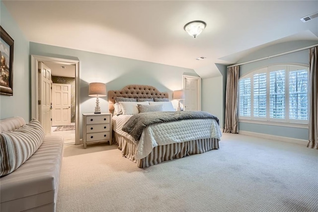 carpeted bedroom with lofted ceiling