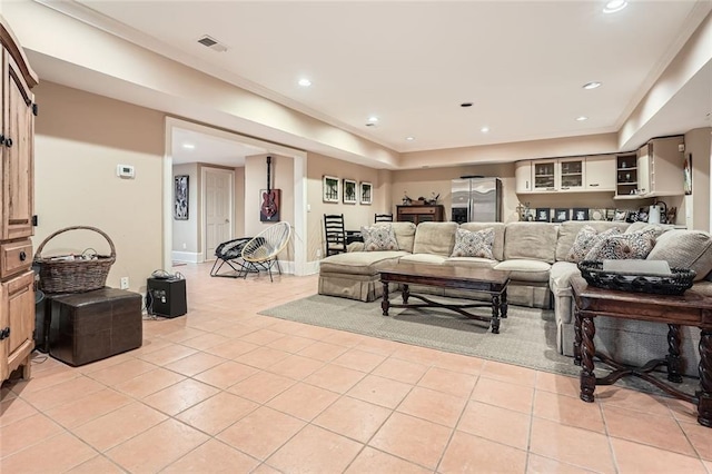 tiled living room featuring crown molding