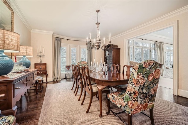 dining space featuring crown molding, dark wood-type flooring, and an inviting chandelier