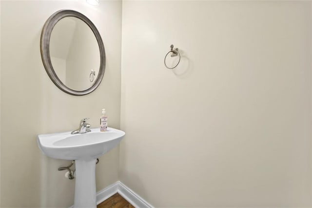 bathroom featuring wood finished floors and baseboards