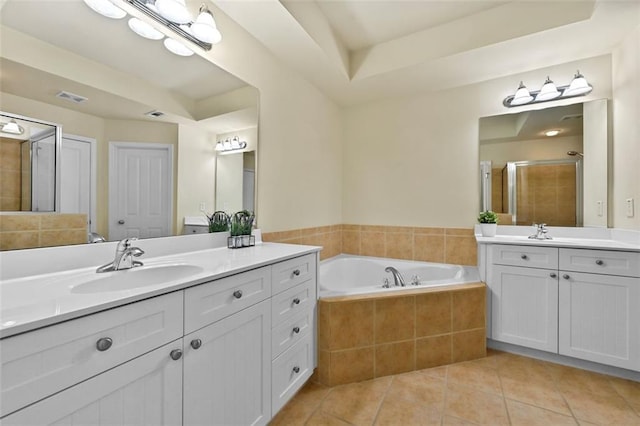 bathroom featuring visible vents, two vanities, a sink, and tile patterned floors