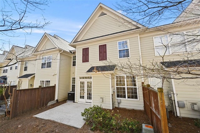 rear view of property with a patio area, fence, and central AC unit