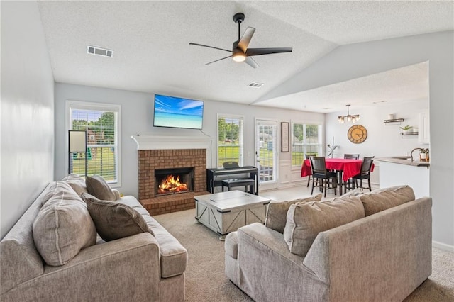 1671 Bismarck Cir, Winder, GA 30680 - living area featuring light carpet, ceiling fan, a fireplace, lofted ceiling, and a textured ceiling