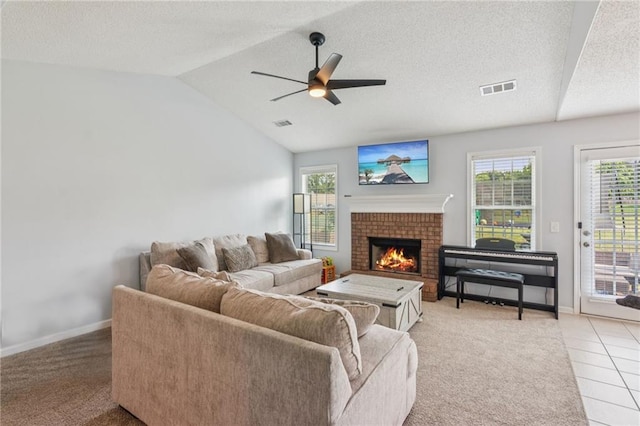 1671 Bismarck Cir, Winder, GA 30680 - living room with a ceiling fan, light colored carpet, a fireplace, baseboards, and lofted ceiling