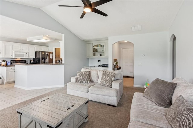 1671 Bismarck Cir, Winder, GA 30680 - living room with arched walkways, ceiling fan, light colored carpet, and vaulted ceiling