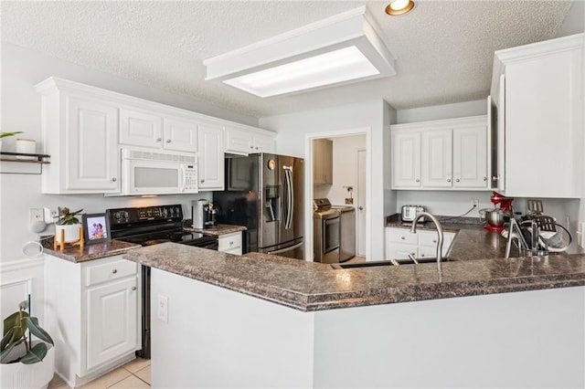1671 Bismarck Cir, Winder, GA 30680 - kitchen featuring white microwave, stainless steel fridge with ice dispenser, a peninsula, dark countertops, and a sink