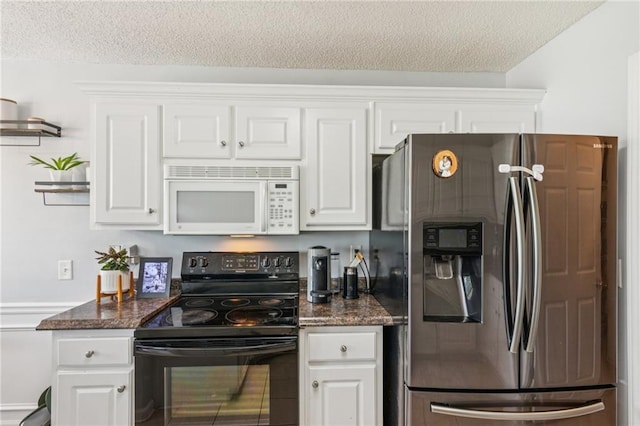 1671 Bismarck Cir, Winder, GA 30680 - kitchen with stainless steel fridge with ice dispenser, white microwave, black range with electric stovetop, a textured ceiling, and white cabinets