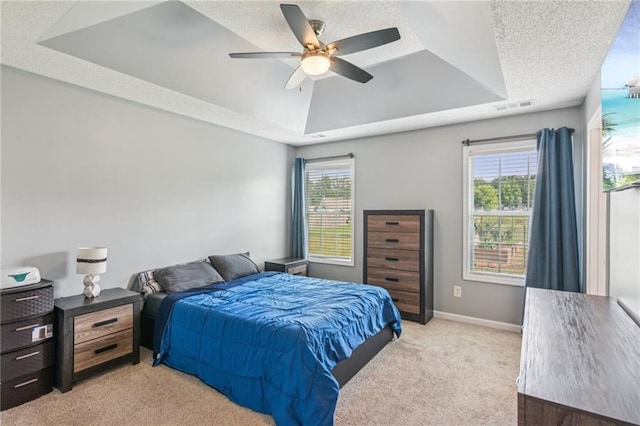 1671 Bismarck Cir, Winder, GA 30680 - bedroom with a tray ceiling, light colored carpet, a ceiling fan, and baseboards