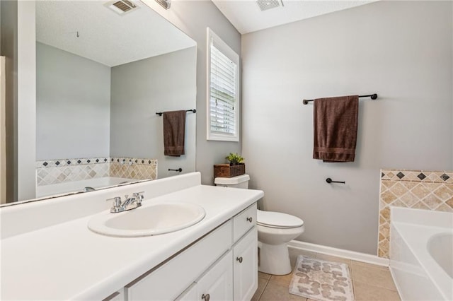 1671 Bismarck Cir, Winder, GA 30680 - bathroom with a garden tub, toilet, vanity, tile patterned floors, and baseboards