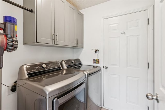 1671 Bismarck Cir, Winder, GA 30680 - washroom with cabinet space, separate washer and dryer, and a textured ceiling