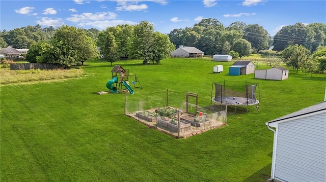 1671 Bismarck Cir, Winder, GA 30680 - view of grassy yard with a garden, a trampoline, and a playground
