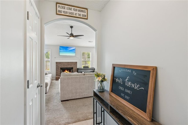 1671 Bismarck Cir, Winder, GA 30680 - hall featuring carpet, arched walkways, a textured ceiling, and tile patterned flooring