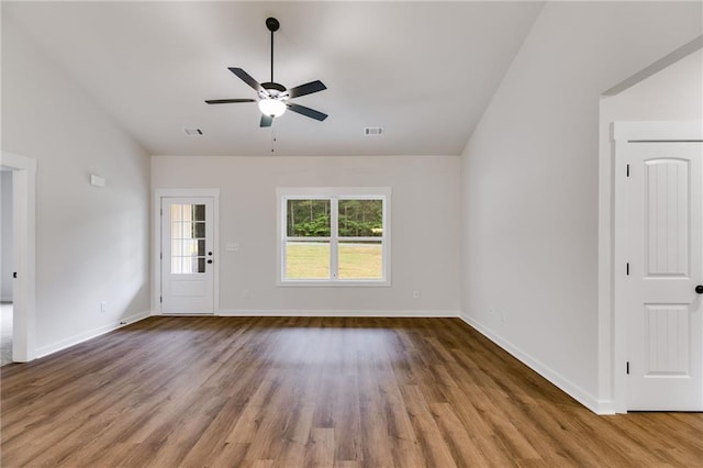 unfurnished room featuring wood finished floors, ceiling fan, baseboards, and lofted ceiling