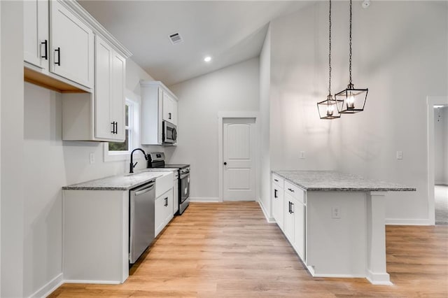 kitchen with appliances with stainless steel finishes, a peninsula, light stone countertops, light wood-style floors, and white cabinets